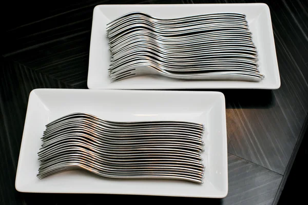 Many forks isolated on a white dish — Stock Photo, Image