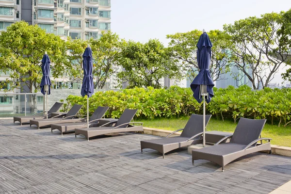 Wooden Pool beds and umbrella with daylight — Stock Photo, Image