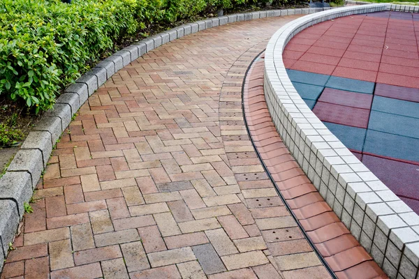 Brick road through garden — Stock Photo, Image