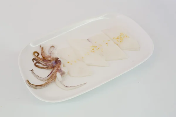 Rebanada de calamar crudo en plato blanco aislar sobre fondo blanco listo —  Fotos de Stock