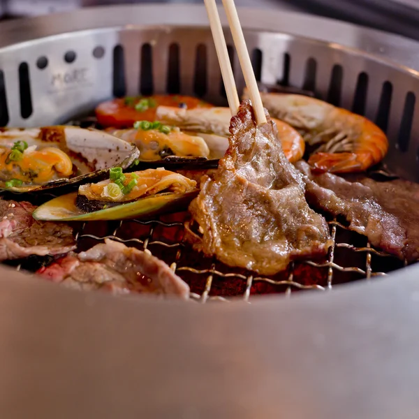 Mixed Roasted Meat and Seafood and Chopsticks on the BBQ Grill o — Stock Photo, Image