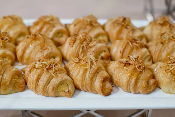 Fresh croissants with toasted coconut for breakfast — Stock Photo, Image