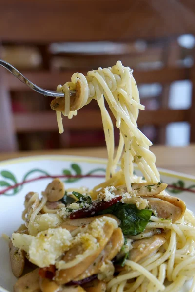 Fork with Spicy Spaghetti with sausage — Stock Photo, Image