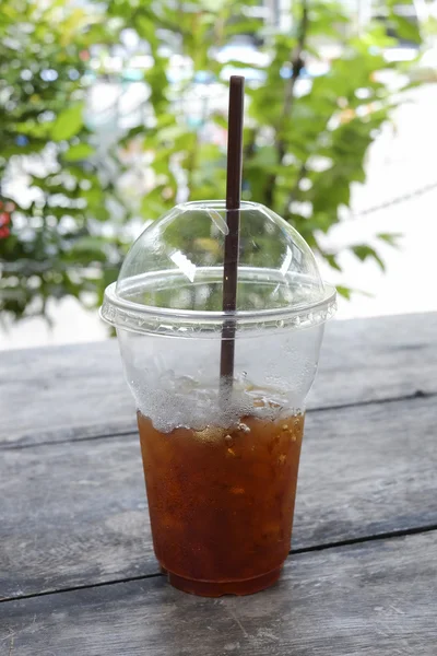 Delicious ice coffee americano with coffee glass lid and straws — Stock Photo, Image