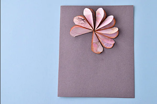 Step-by-step photo instruction how to make a greeting card with a flower. Step 9. Ready-to-look glued hearts on the basis of a postcard