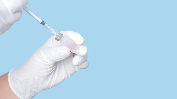 Vaccine Bottle Syringe Hand Wearing White Rubber Gloves Isolated Blue Stock Image