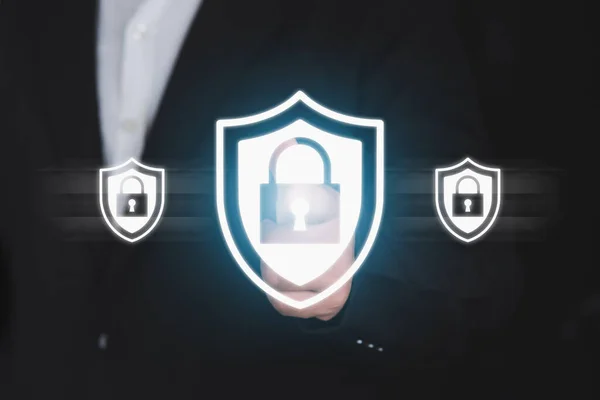 Businessman pressing security shield.Technology computer and internet cyber security and anti-virus concept.