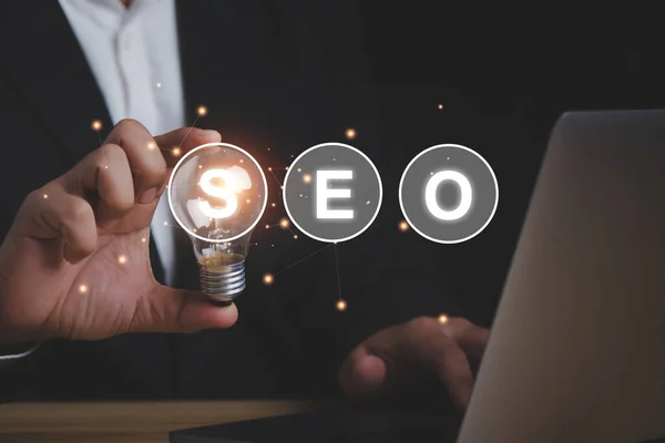 Seo Search Engine Optimization Concept Businessman Holding Lighting Bulb Idea — Stock Photo, Image
