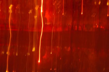 Abstract vertical red light streaks texture. Dramatic falling fire rain or curtain background fitting Opera aesthetic.