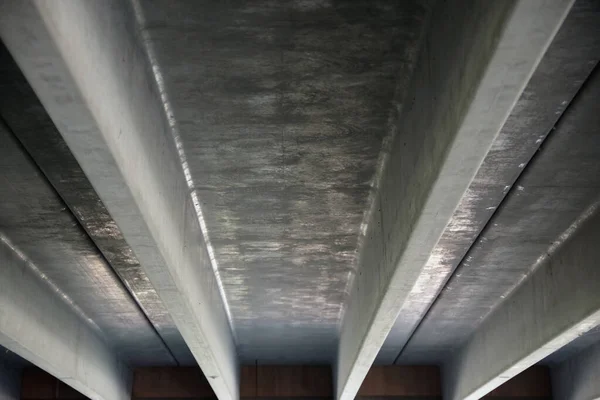 Low angle view of the ceiling of the lowest level of a large multi story parking garage structure