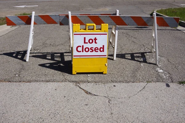 Lot Closed - temporary traffic sign and road block at a parking lot entrance