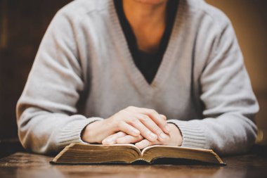 Hristiyan hayatı, Tanrı 'ya dua etmek. Daha iyi bir hayat dilemek için Tanrı 'ya dua et. Kadın elleri İncil 'le Tanrı' ya dua ediyor. Bağışlanmak için yalvarıyor ve iyiliğe inanıyordu..