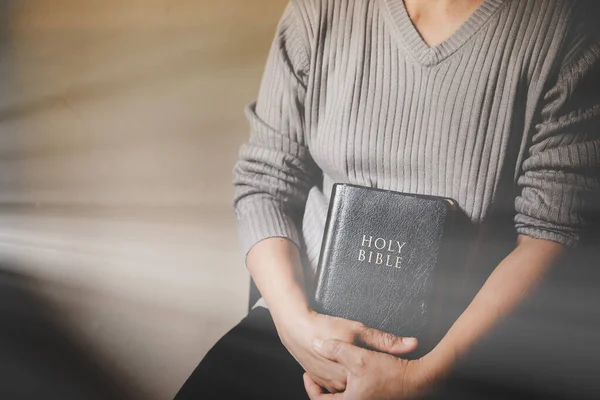 Christian life crisis prayer to god. Woman Pray for god blessing to wishing have a better life. woman hands praying to god with the bible. begging for forgiveness and believe in goodness.