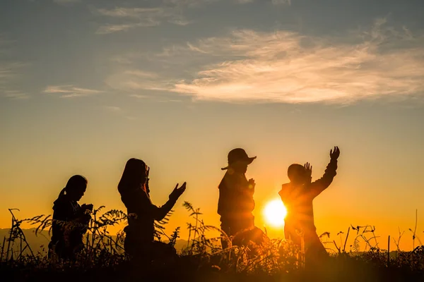 four girl bowed and prayed at sunset in the mountains, Eucharist Therapy Bless God Helping Repent Catholic Easter Lent Mind Pray. Christian Religion concept background. fighting and victory for god