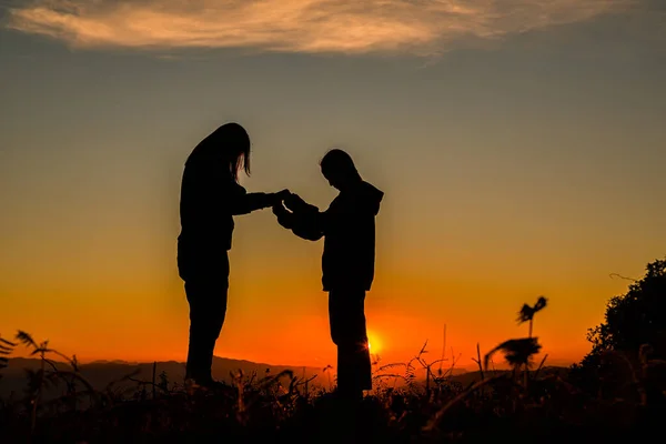 Two girl bowed and prayed at sunset in the mountains, Eucharist Therapy Bless God Helping Repent Catholic Easter Lent Mind Pray. Christian Religion concept background. fighting and victory for god