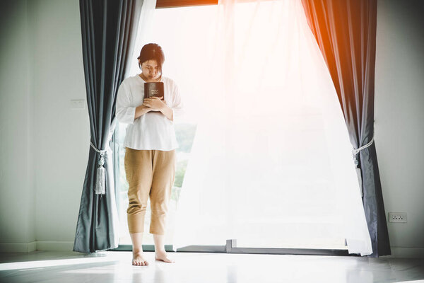 Christian life crisis prayer to god. Young woman pray for god blessing to wishing have a better life. Girl hands praying to god with the bible. begging for forgiveness and believe in goodness.