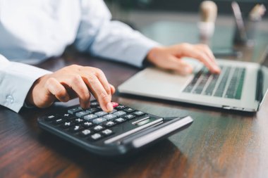 İş kadını, mali stratejiye odaklı bir işletme, finans ve gayrimenkul kavramını gösteren maliyet, vergi, yatırım hesaplarını hesaplamak için bankacılık ve muhasebe sistemini kullanarak finansmanı yönetir..