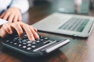 İş kadını, mali stratejiye odaklı bir işletme, finans ve gayrimenkul kavramını gösteren maliyet, vergi, yatırım hesaplarını hesaplamak için bankacılık ve muhasebe sistemini kullanarak finansmanı yönetir..