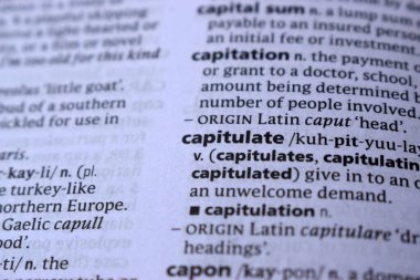 Definition Of English Dictionary Close Up Of Page Print With Word - capitulate