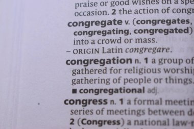 English Dictionary Book Page Close Up With The Word Definition Of - congregate