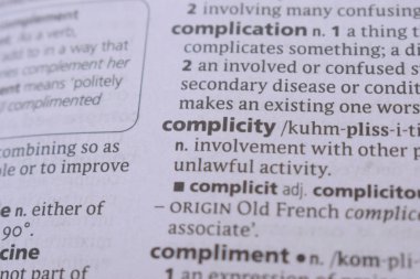 English Dictionary Book Page Close Up With The Word Transcription Of -complicity