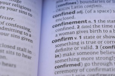 English Dictionary Book Page Close Up With The Word Definition Of - confirm
