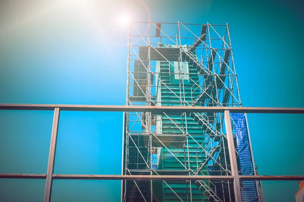 Scaffolding in construction against blue sky.labor protection concept