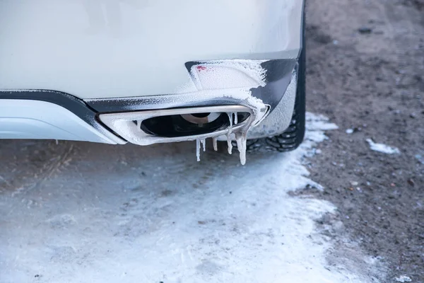 Frozen car, exhaust pipe with icicles, rear view, snow, ice, winter