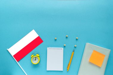 Yabancı dil öğrenme zamanı. Lehçe kursları için düz kompozisyon ve mavi arkaplan üzerine metin için boşluk.