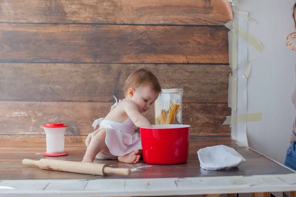 Little baby chef on wooden background. In apron. — Stock Photo, Image