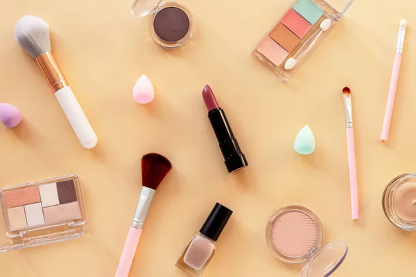 Makeup cosmetic products on neutral color background. Top view, flat lay. Fashion, beauty concept.