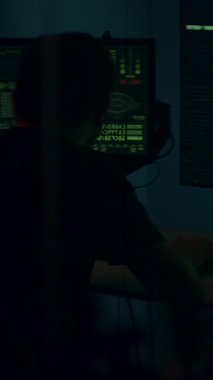 Siber güvenlik analisti kod ve verilerle dolu çoklu ekran ile meşgul, yüksek teknolojili bir ortam, çalışma alanı elementlerini yakalamak için kamera tavaları