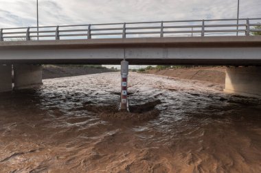 Rising river water after heavy rainfall. Measurements on bridge.