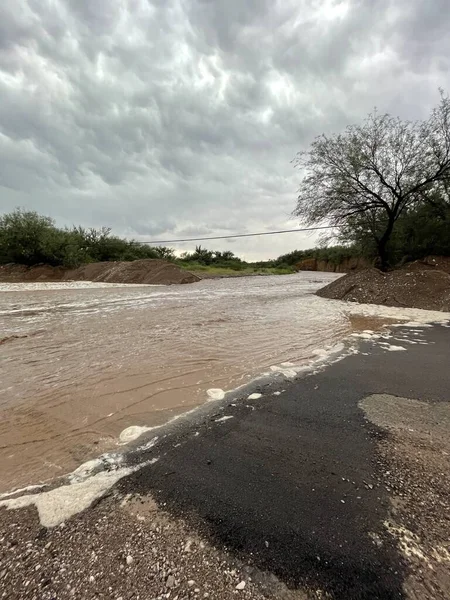 Flash flood on a rural Arizona road after summer monsoon