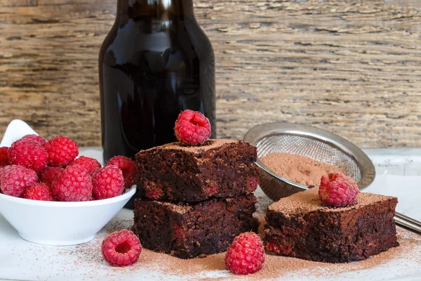 Chocolate brownie with raspberries and dark beer. Selective focus