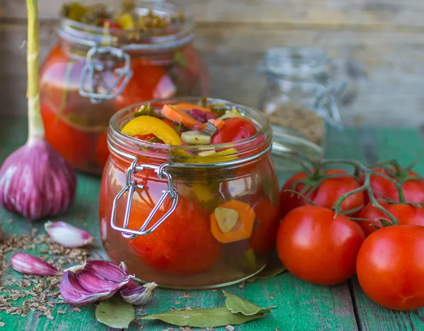 Pickles. Canned tomatoes. tomatoes in glass jar on wooden table. Fresh tomatoes