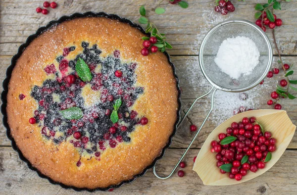 Sponge cake with berries - cranberries and blueberries