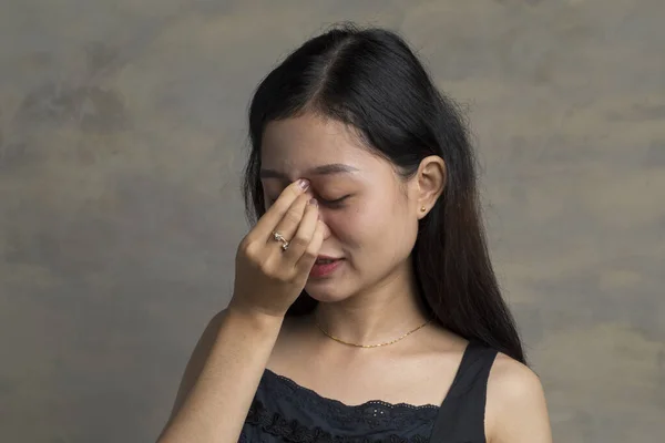 Asian Woman feeling eye pain