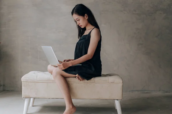 Asian beautiful woman thinking idea with laptop computer