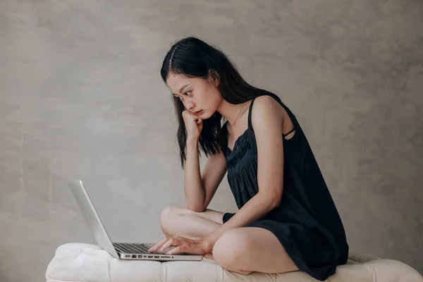 Asian beautiful woman thinking idea with laptop computer