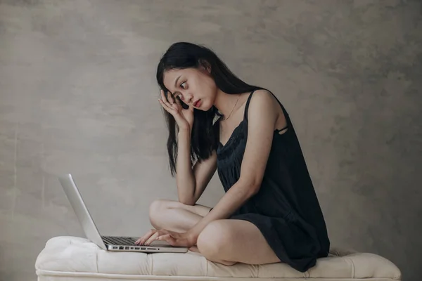 Asian beautiful woman thinking idea with laptop computer