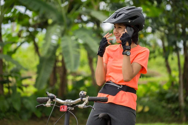 Ασιάτισσα Ποδηλάτης Χρήση Smartphone Κατά Την Οδήγηση Ποδήλατο Στο Δάσος — Φωτογραφία Αρχείου
