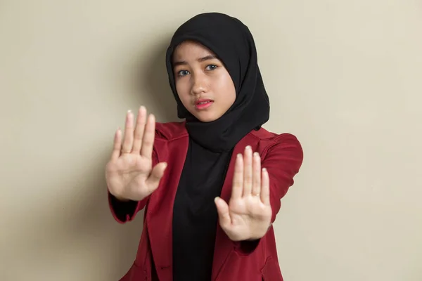Asian muslim hijab woman show stop hands gesture