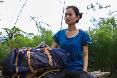 Asyalı kadın yürüyüş yaparken mola veriyor.