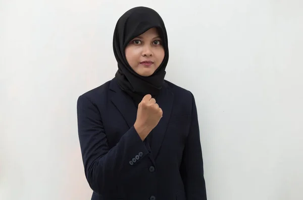 Asian woman wearing hijab happy and excited celebrating victory expressing big success power energy and positive emotions. Celebrates new job joyful
