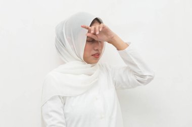 Stresli, başı ağrıyan Müslüman kadın portresi; baş dönmesi, baş dönmesi, migren, akşamdan kalma, sağlık hizmeti konsepti; genç yetişkin Asyalı kadın modeli