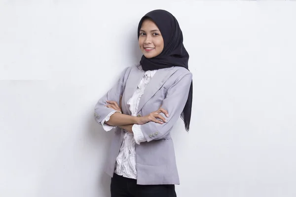 Young asian muslim woman in head scarf smile with arms crossed on white background