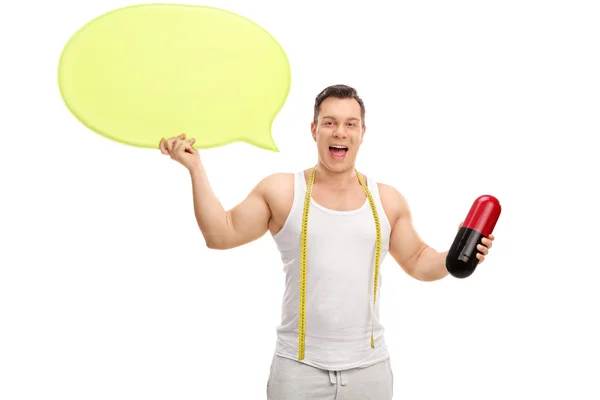 Man with huge pill and speech bubble — Stock Photo, Image