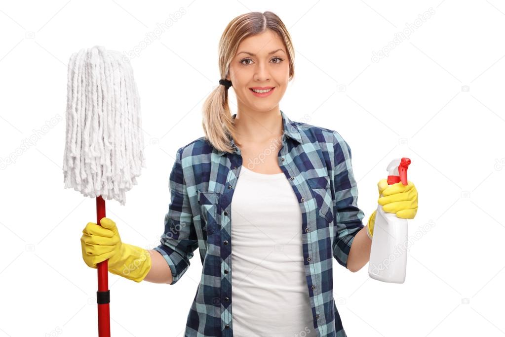 Young woman holding a mop and a spray  