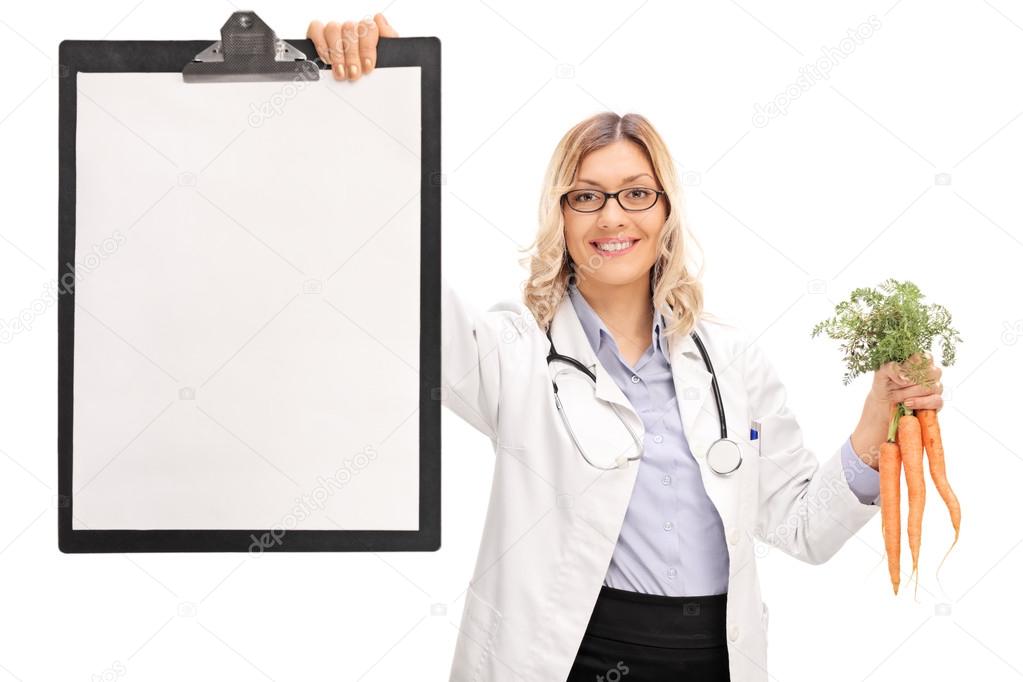 Female doctor holding a clipboard and carrots 